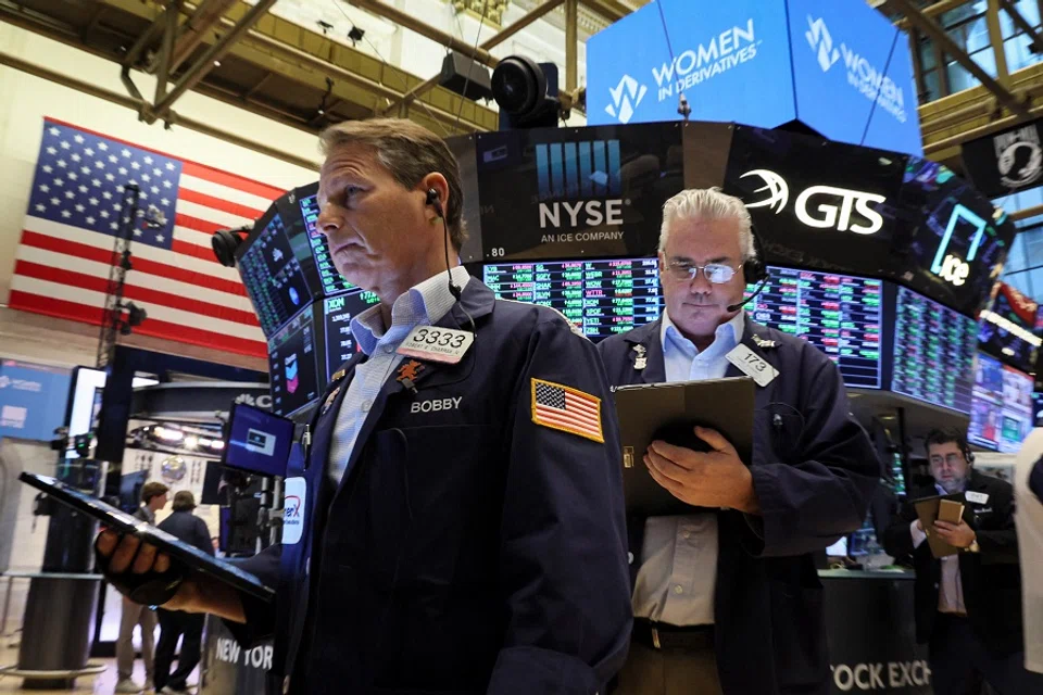 Traders work on the floor of the New York Stock Exchange (NYSE) in New York City, US, 16 March 2022. (Brendan McDermid/Reuters)