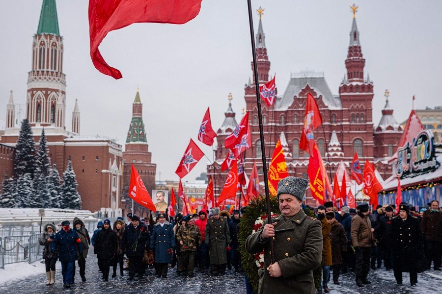 Russian Communist party supporters march to lay flowers to the tomb of late Soviet leader Joseph Stalin during a memorial ceremony to mark the 142nd anniversary of his birth at Red Square in Moscow, Russia, on 21 December 2021. (Dimitar Dilkoff/AFP)