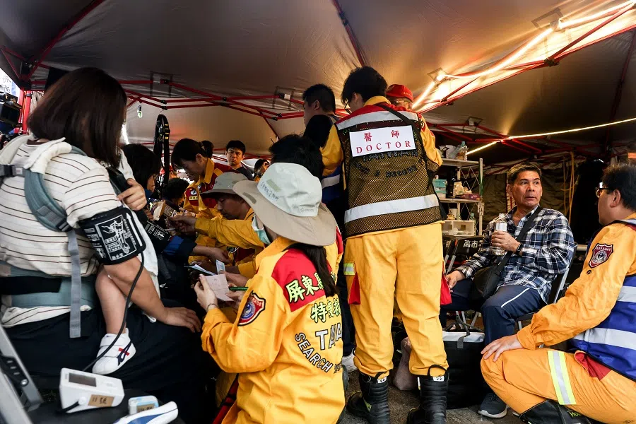 People receive medical attention at a temporary rescue command post after being rescued from the Taroko National Park in Hualien, Taiwan, on 5 April 2024 following the 3 April earthquake. (I-Hwa Cheng/AFP)
