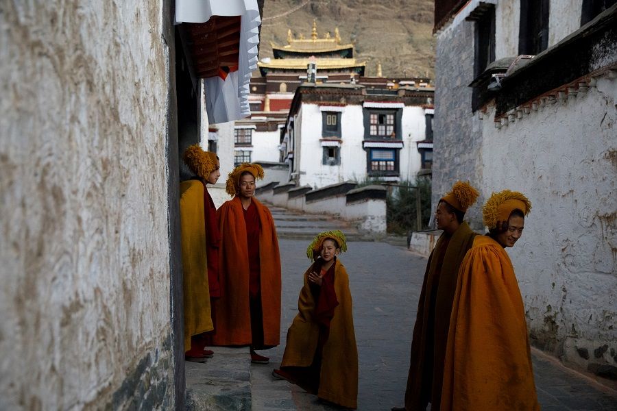 Monks leave morning prayers at Tashi Lhunpo Monastery in Shigatse, Tibet Autonomous Region, China, 18 October 2020. (Thomas Peter/Reuters)