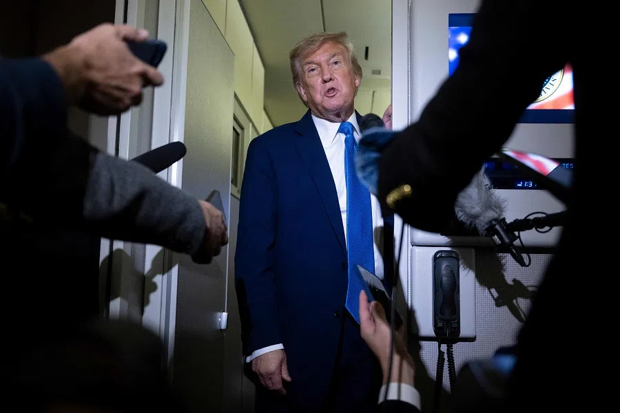 US President Donald Trump speaks to reporters aboard Air Force One while travelling back to Washington from Canada on 16 June 2025. (Brendan Smialowski/AFP)
