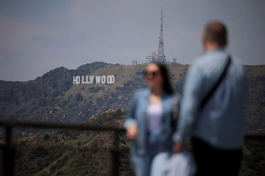 Visitors take photos with the Hollywood sign in the background from the Griffith Observatory in Los Angeles, California, US, on 1 May 2025.
