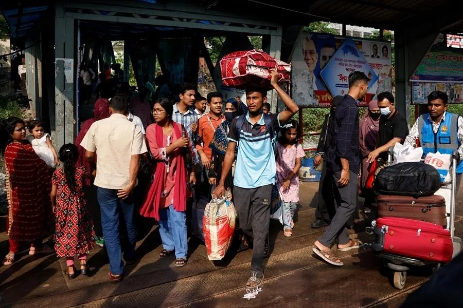People arrive at the Sadarghat Ferry Terminal to board passenger ferries, as they leave Dhaka to celebrate Eid al-Fitr with their families, in Dhaka, Bangladesh, on 17 March 2026.