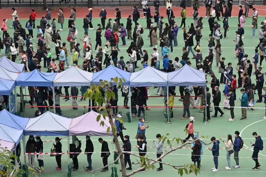 People queue at a mobile specimen collection station for Covid-19 testing in Hong Kong's Mongkok district on February 10, 2022. (Peter Parks/AFP)