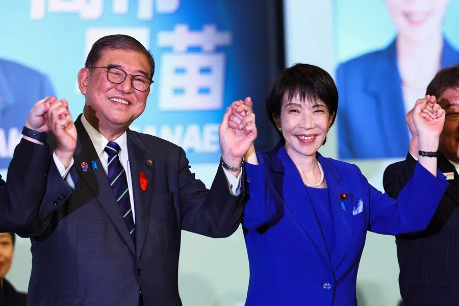 Newly-elected leader of Japan’s Liberal Democratic Party (LDP) Sanae Takaichi (right) celebrates with Prime Minister Shigeru Ishiba after winning the LDP leadership election in Tokyo on 4 October 2025