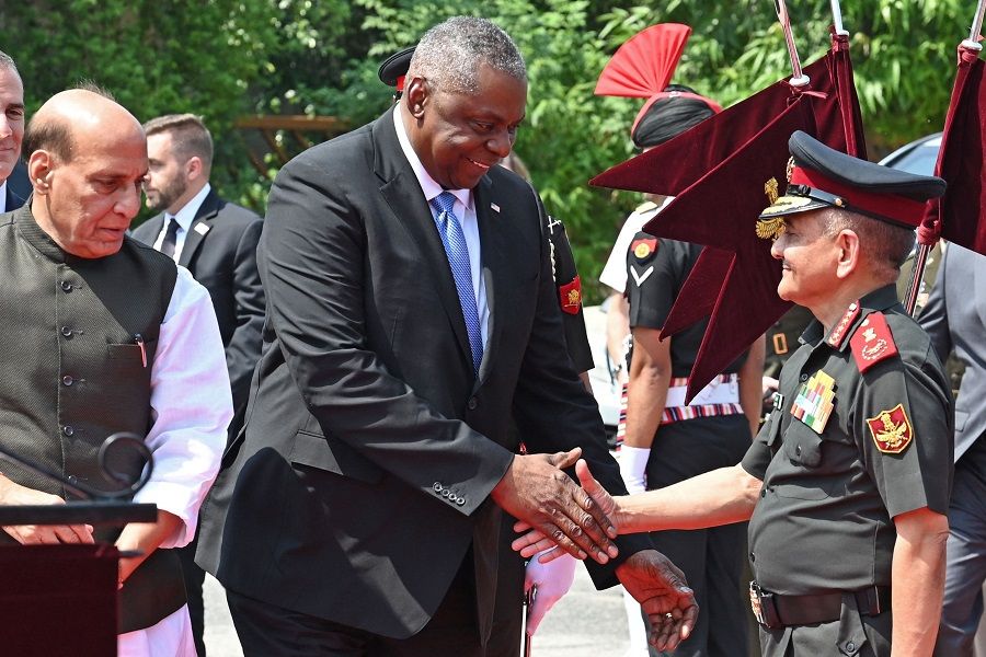 US Defence Secretary Lloyd Austin (centre) shakes hands with India's Chief of Defence Staff General Anil Chauhan as Defence Minister Rajnath Singh (left) watches before Austin's ceremonial reception at the Manekshaw Centre in New Delhi, India, on 5 June 2023. (Arun Sankar/AFP)