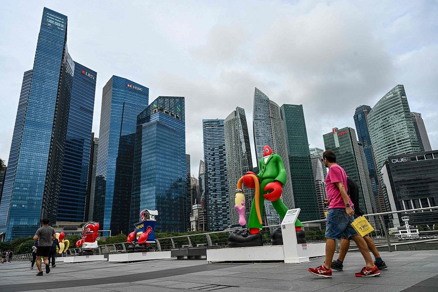 People walk along the promenade at Marina Bay in Singapore on 1 February 2023. (Roslan Rahman/AFP)