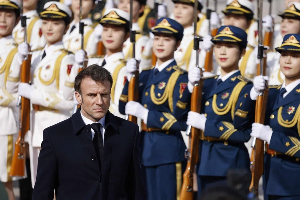 French President Emmanuel Macron reviews an honour guard with Chinese President Xi Jinping (not pictured) during the official welcoming ceremony in Beijing, China, on 6 April 2023. (Ludovic Marin/AFP)