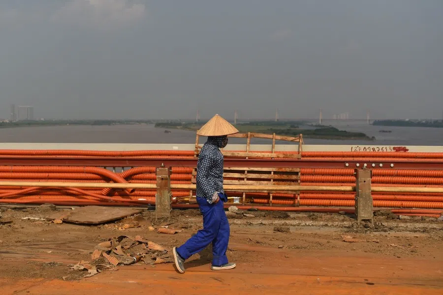 A worker walks on Thang Long bridge during a major renovation in Hanoi on 27 August 2020. (Nhac Nguyen/AFP)