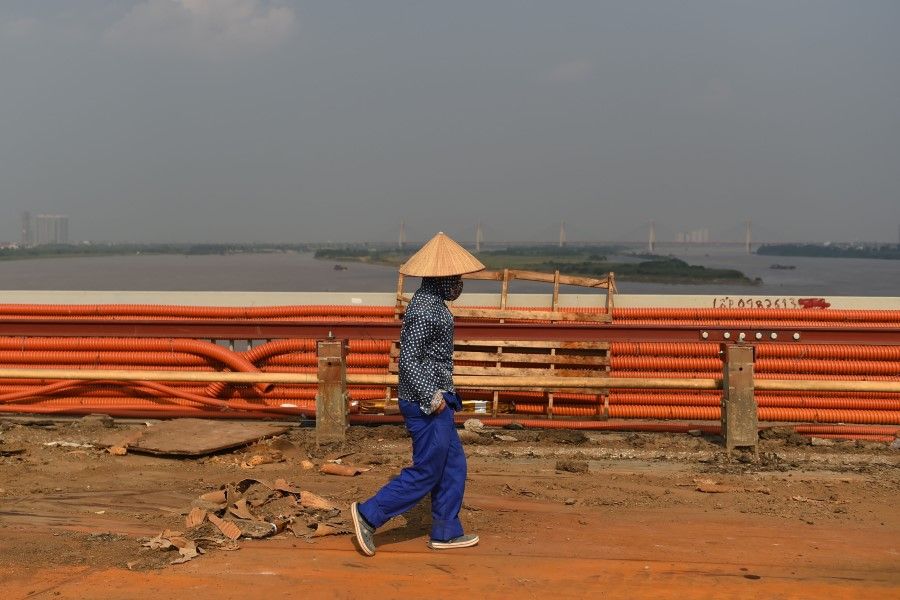 A worker walks on Thang Long bridge during a major renovation in Hanoi on 27 August 2020. (Nhac Nguyen/AFP)