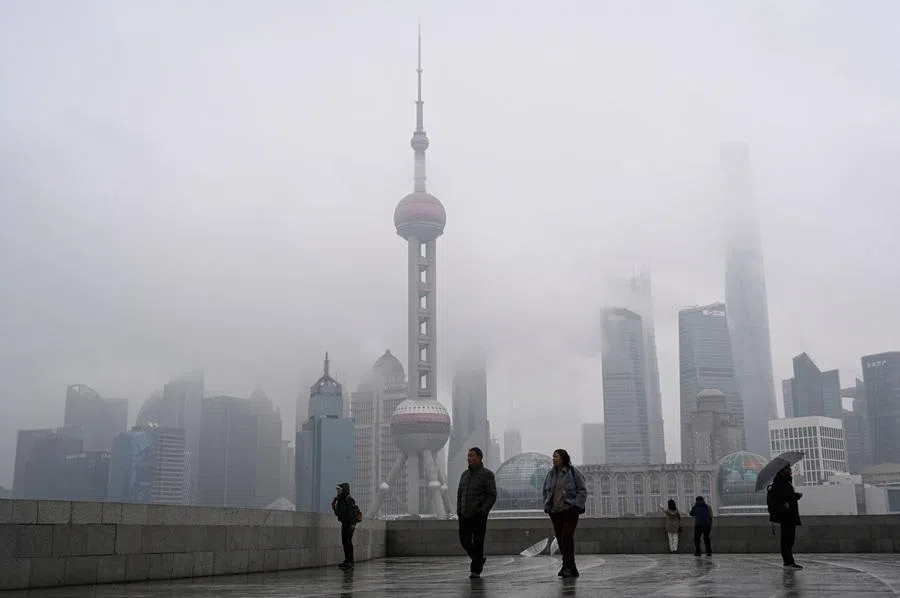 People walk on the Bund promenade along the Huangpu River in Shanghai on 5 March 2026. (Jade Gao/AFP)