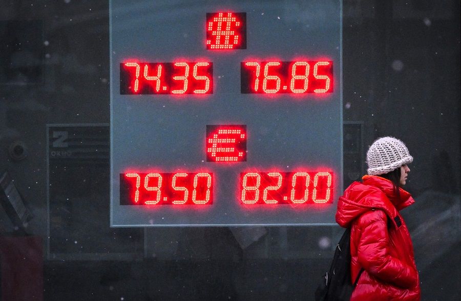 A pedestrian walks past a board at a currency exchange office in Moscow, Russia, on 16 February 2023. (Yuri Kadobnov/AFP)