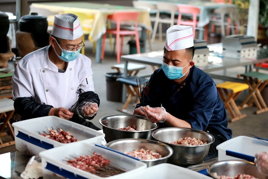 Chefs prepare meat skewers at a barbecue eatery in Zibo, Shandong province, China, 31 March 2023. (CNS)