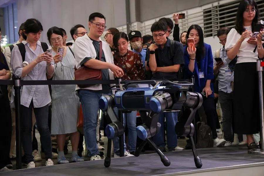 Visitors observe Pegatron’s robot dog during the annual Computex trade show in Taipei, Taiwan, on 2 June 2026.