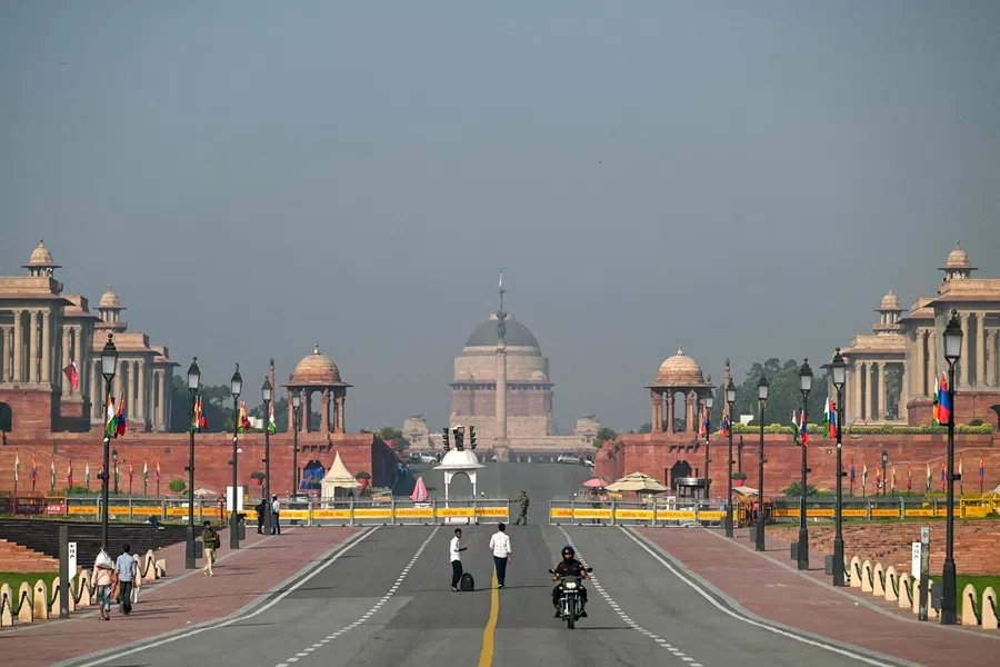 People walk past Kartavya Path near India’s presidential palace Rashtrapati Bhavan in New Delhi on 14 October 2025. (Arun Sankar/AFP)