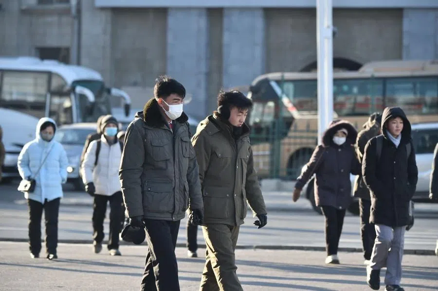 People walk in the street amid cold weather in Pyongyang on 20 January 2026.