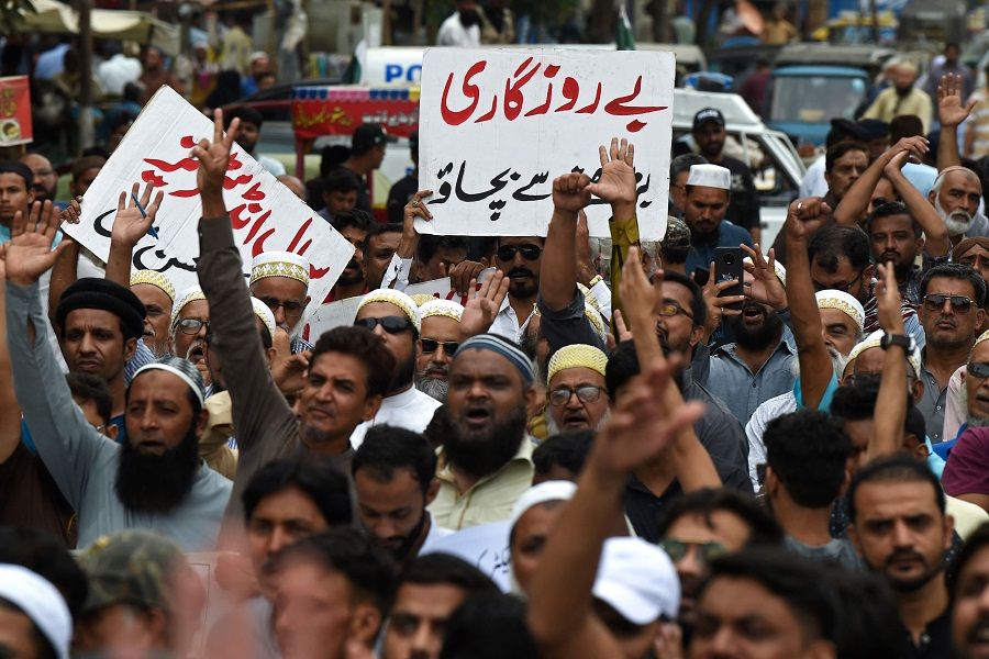 A trader holds a placard reading "Prevent Unemployment from Rising" during a protest at a street in Karachi, Pakistan on 23 August 2023, against the surge in petrol and electricity prices as Pakistan endures soaring inflation. (Asif Hassan/AFP)