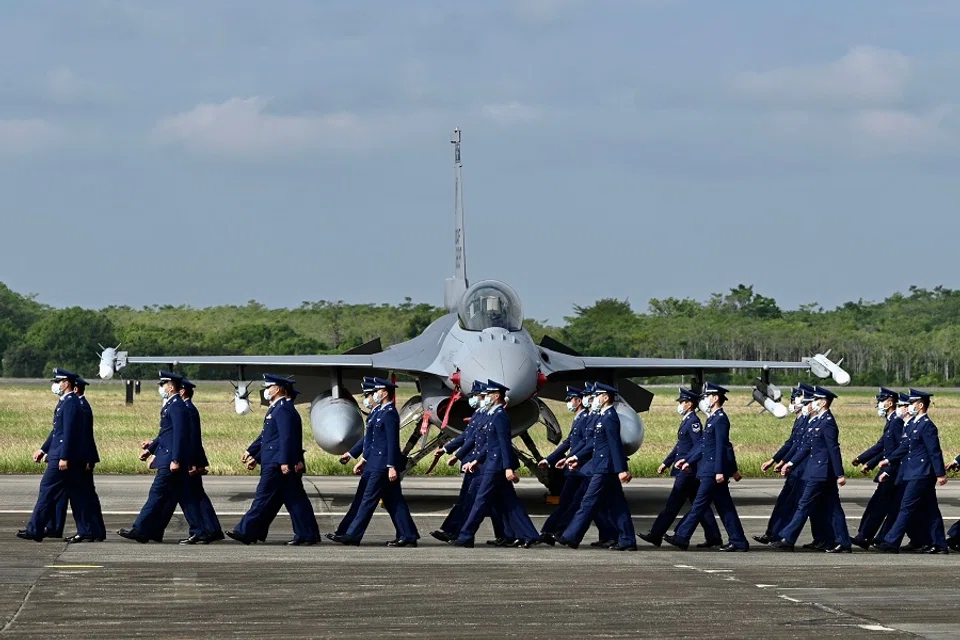 Taiwan Air Force staffers walk past an upgraded US-made F-16 V fighter during a ceremony at the Chiayi Air Force Base in Taiwan on 18 November 2021. (Sam Yeh/AFP)
