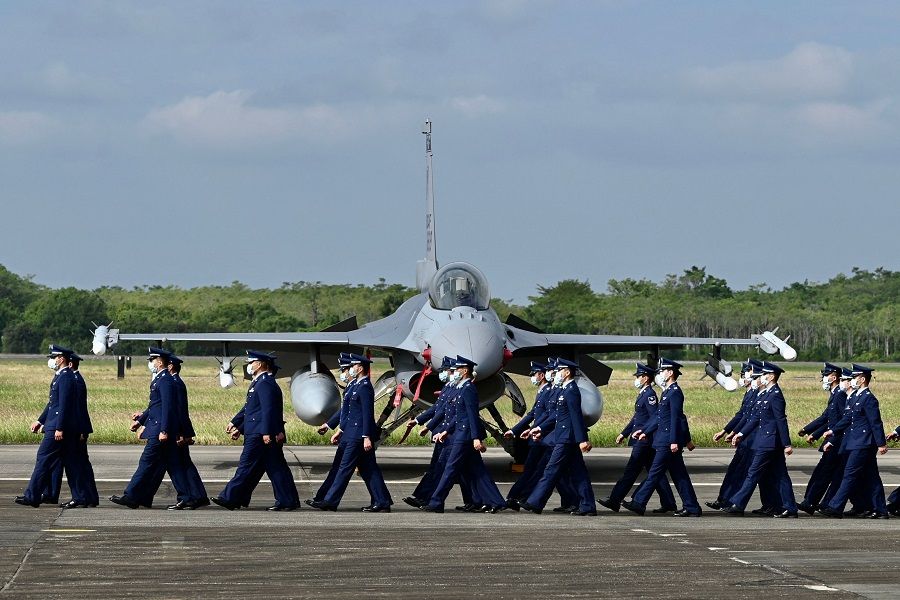Taiwan Air Force staffers walk past an upgraded US-made F-16 V fighter during a ceremony at the Chiayi Air Force Base in Taiwan on 18 November 2021. (Sam Yeh/AFP)