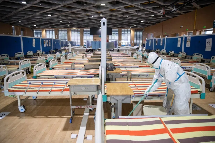 This photo taken on March 10, 2020 shows a medical staff member cleaning the floor after all patients were discharged at a temporary hospital set up to treat people with the Covid-19 coronavirus in Wuhan. The Chinese government is holding up China as an example in controlling the epidemic. (STR/AFP)