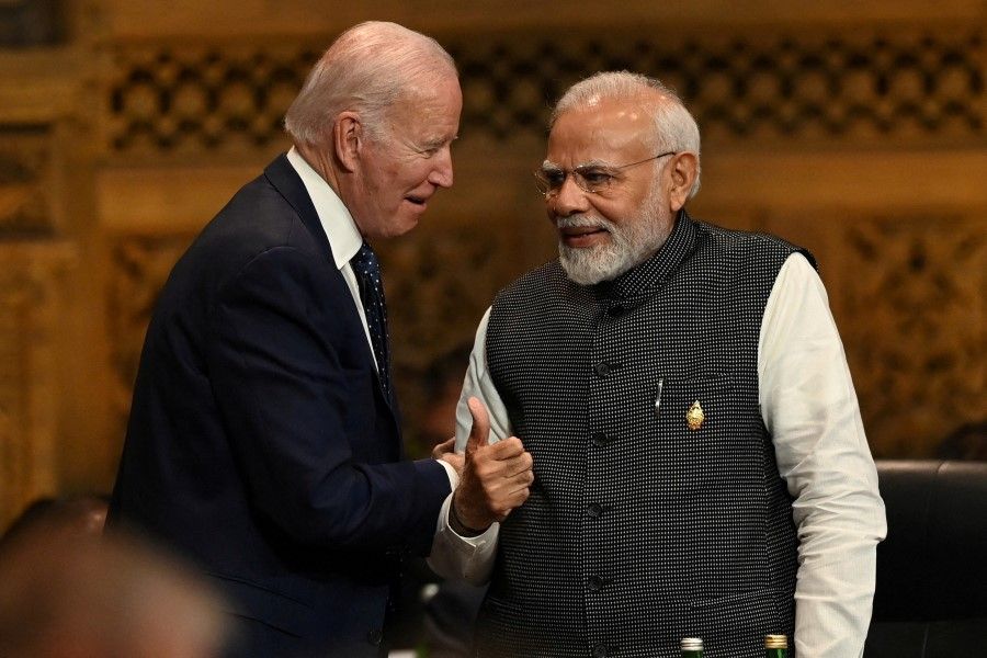 US President Joe Biden (left) speaks with Indian Prime Minister Narendra Modi at the G20 Summit opening session in Nusa Dua, Bali, Indonesia, 15 November 2022. (Prasetyo Utomo/G20 Media Center/Handout via Reuters)
