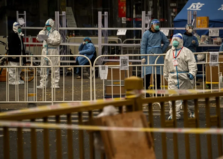 Security personnel wearing personal protective equipment (PPE) guards the entrance to a residential area under lockdown due to Covid-19 coronavirus restrictions in Beijing on 22 November 2022. (Noel Celis/AFP)
