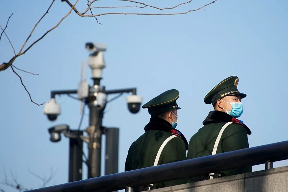 Paramilitary police members wearing protective face masks stand near surveillance cameras at the Bund, in Shanghai, China, 20 January 2022. (Aly Song/File Photo/Reuters)