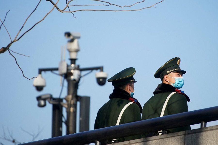Paramilitary police members wearing protective face masks stand near surveillance cameras at the Bund, in Shanghai, China, 20 January 2022. (Aly Song/File Photo/Reuters)