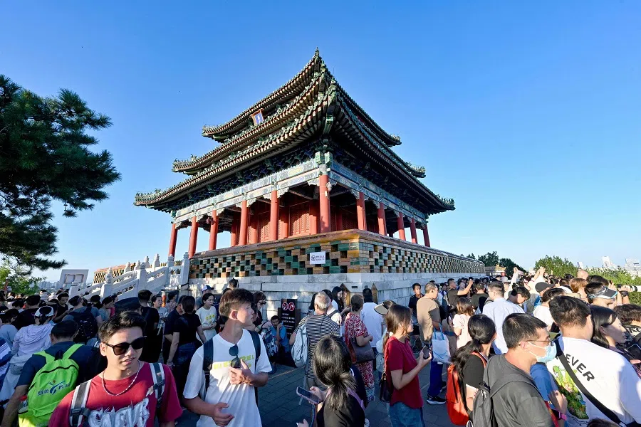 People visit the Jingshan park overseeing the Forbidden City in Beijing, China, on 27 August 2024. (Adek Berry/AFP)