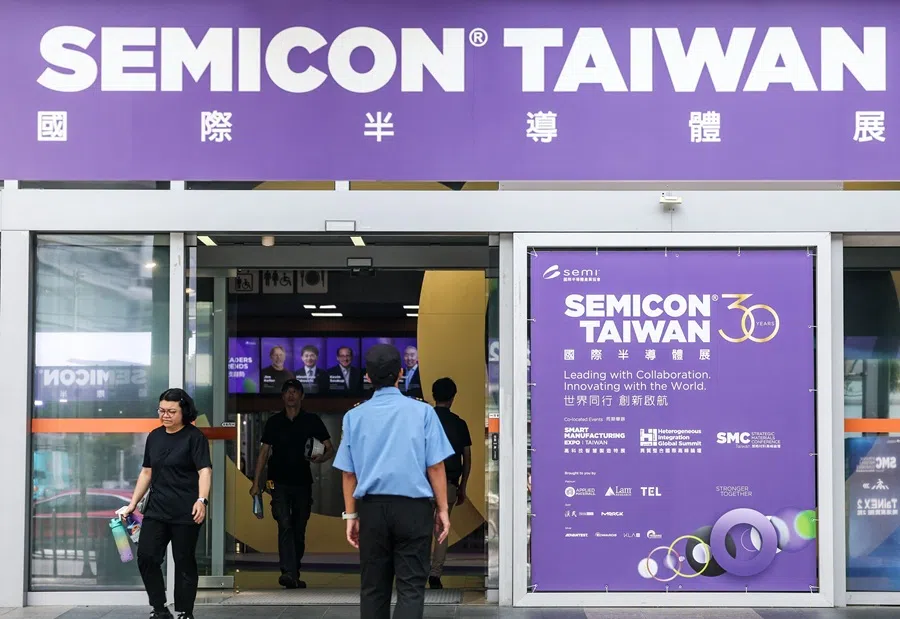 People walk past signage of the SEMICON Taiwan exhibition in Taipei on 9 September 2025. (I-Hwa Cheng/AFP)