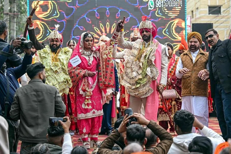 Couples dance during a mass wedding ceremony in Amritsar on 5 January 2026. (Narinder Nanu/AFP)