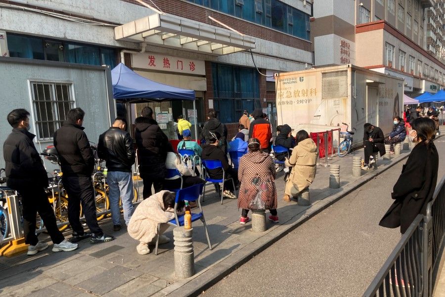 People line up at a fever clinic of a hospital, after the government gradually loosened the restrictions on Covid-19 control, in Wuhan, Hubei province, China, 10 December 2022. (Martin Pollard/Reuters)