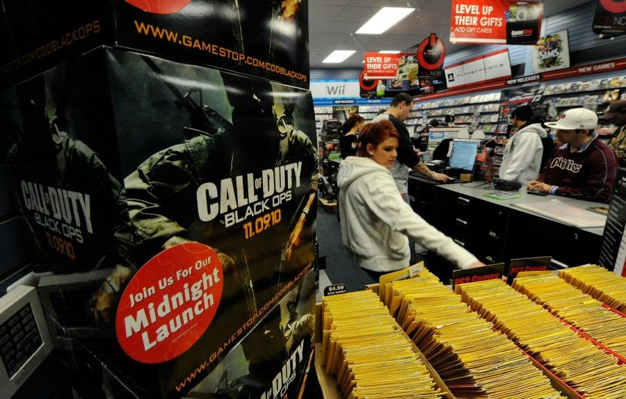 In this file photo taken on 9 November 2010, customers buy copies of the video game "Call of Duty: Black Ops" at a GameStop Corp. store in North Las Vegas, Nevada. Microsoft announced on 18 January 2022 a US$69 billion deal to purchase US gaming giant Activision Blizzard, the firm behind hits like "Call of Duty". (Ethan Miller/AFP)
