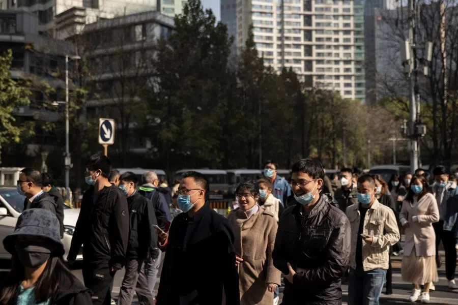 People cross a street in the Central Business District (CBD) on the day that Chinese leaders elaborate on their 14th Five-Year plan following an outbreak of the coronavirus disease (COVID-19) in Beijing, China, 30 October 2020. (Thomas Peter/REUTERS)