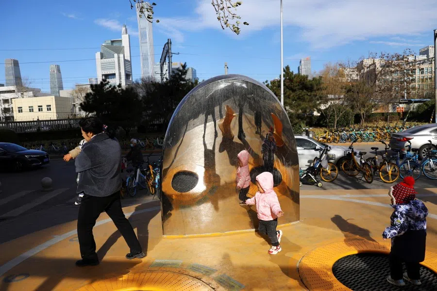 Children play at an open space near Beijing's Central Business District (CBD), China, 2 December 2021. (Tingshu Wang/Reuters)