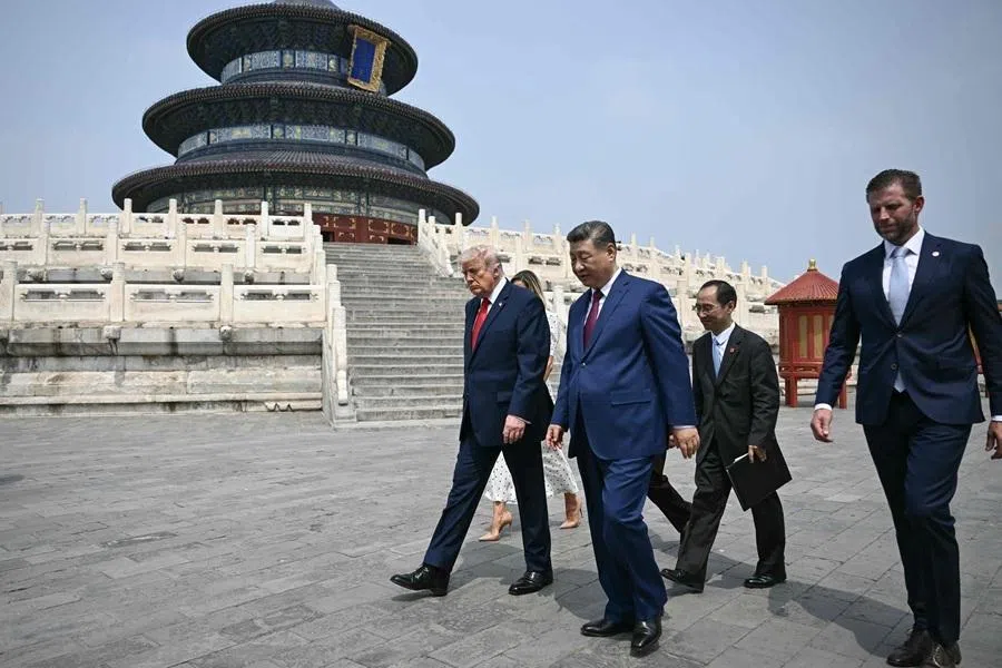China's President Xi Jinping (C), US President Donald Trump (L) and Eric Trump (R) visit the Temple of Heaven in Beijing on 14 May 2026. (Brendan Smialowski/Pool/AFP)