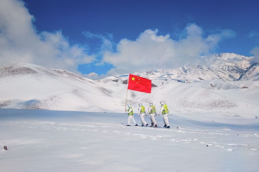 This photo taken on 7 October 2021 shows police officers patrolling along the border in Ili Kazakh Autonomous Prefecture, Xinjiang Uyghur Autonomous Region, China. (STR/AFP)