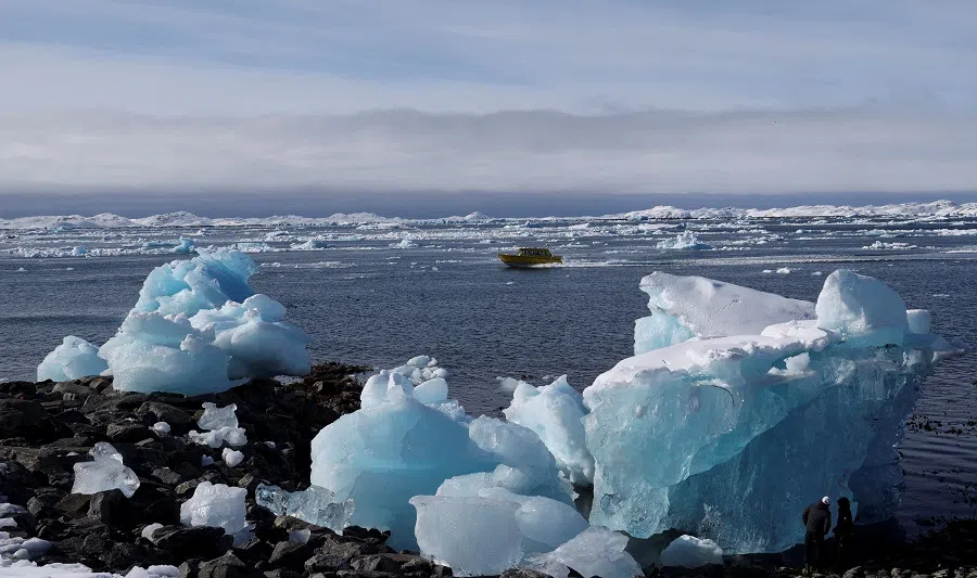 A tourist boat passes chunks of ice in the fjord of Nuuk, Greenland, on 30 March 2025. (Leonhard Foeger/Reuters)