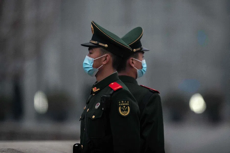 Chinese soldiers stand guard near Tiananmen Square in Beijing, China, on 5 March 2021. (Nicolas Asfouri/AFP)