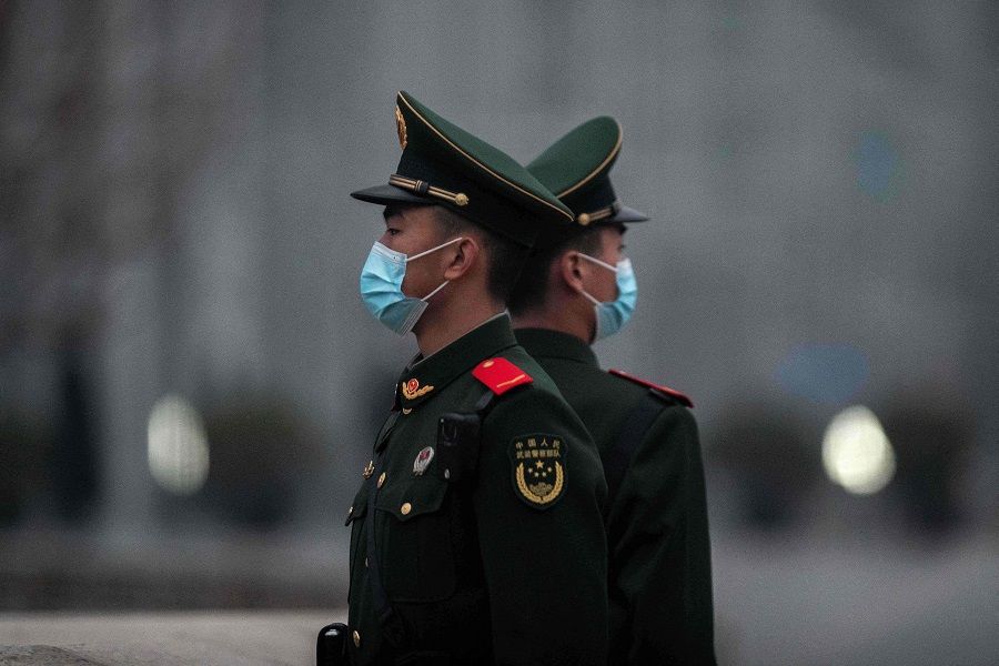 Chinese soldiers stand guard near Tiananmen Square in Beijing, China, on 5 March 2021. (Nicolas Asfouri/AFP)