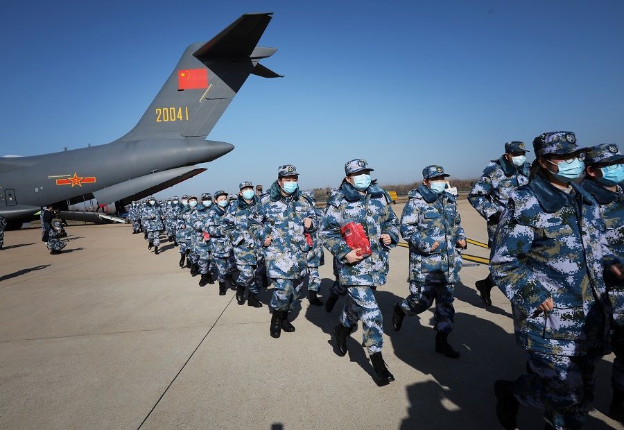 Medical personnel arrive in transport aircraft of the Chinese People's Liberation Army (PLA) Air Force at the Wuhan Tianhe International Airport following the outbreak of the Covid-19 coronavirus in Wuhan, Hubei province, China, on 17 February 2020. (China Daily via Reuters)