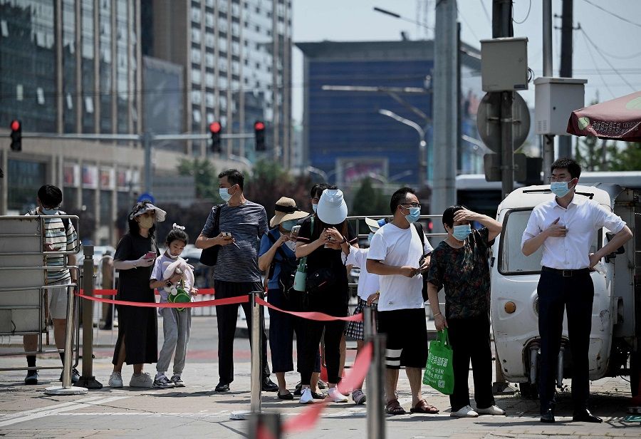 People queue to be tested for the Covid-19 coronavirus at a swab collection site in Beijing, China, on 21 July 2022. (Noel Celis/AFP)