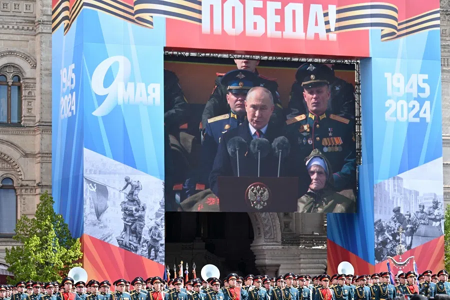 Russian honour guards soldiers stand next to a screen broadcasting Russia’s President Vladimir Putin’s address during the Victory Day military parade on Red Square in Moscow, Russia, on 9 May 2024. (Natalia Kolesnikova/AFP)