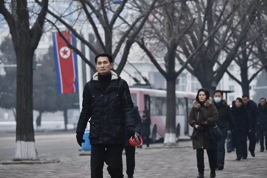 People walk on a street outside Pyongyang Department Store No. 1 on the 83rd birth anniversary of late North Korean leader Kim Jong Il in Pyongyang on 16 February 2025. (Kim Won Jin/AFP)