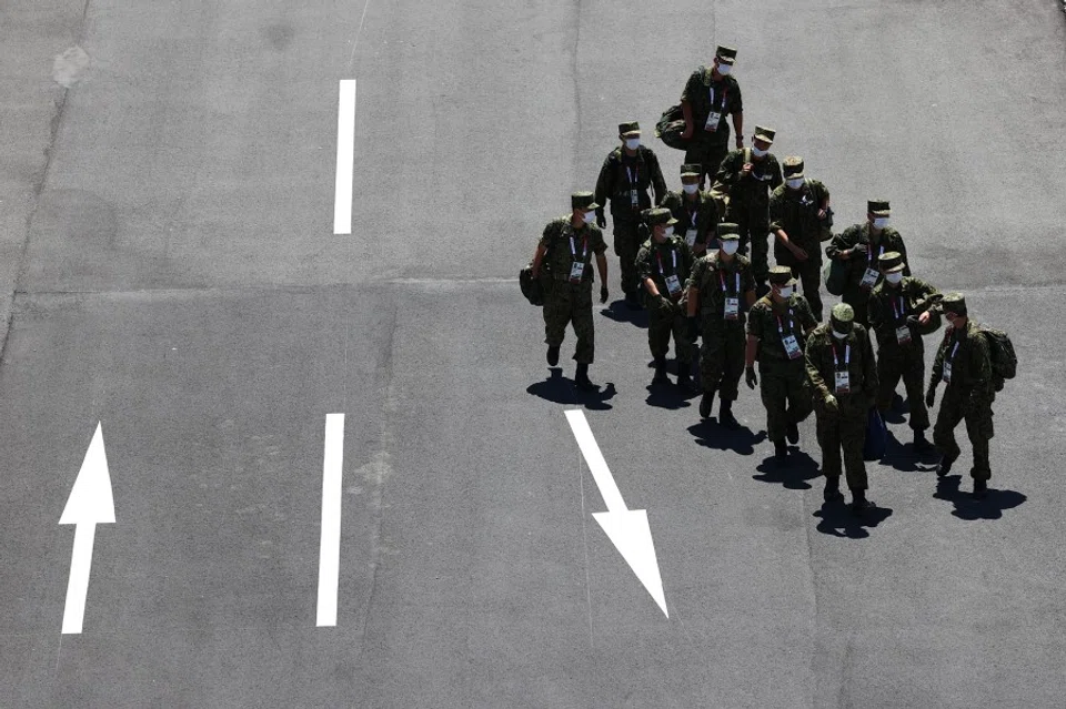 Members of the Japanese Armed Forces walk past the Ariake Urban Sports Park in Tokyo, Japan, 18 July 2021 (Kim Kyung-Hoon/Reuters)