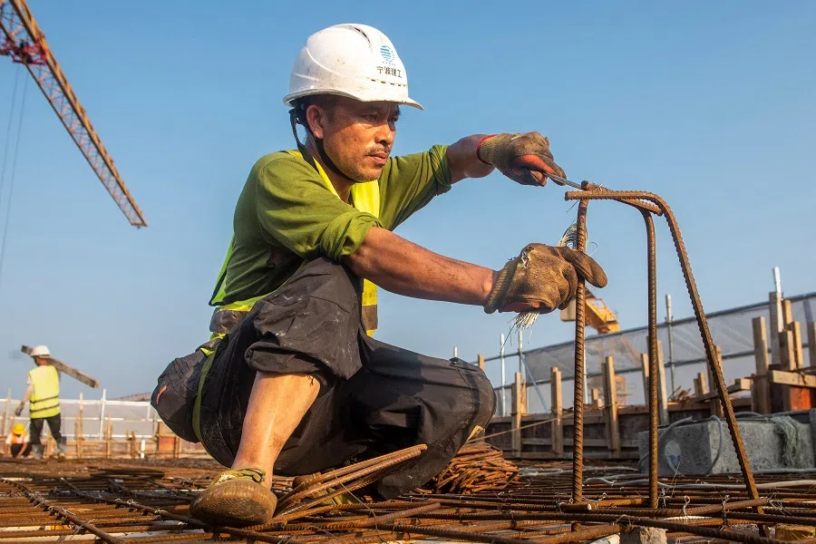 The photo taken on 17 September 2023 shows a worker at a construction site of a housing project in Ningbo, in China's eastern Zhejiang province. (AFP)