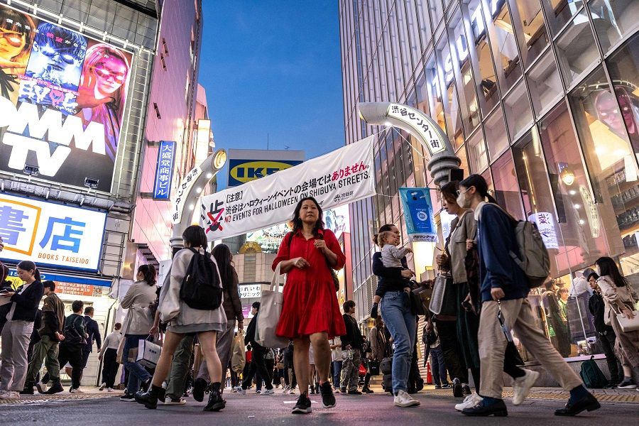 Pedestrians walk at Shibuya Crossing in the Shibuya district of Tokyo, Japan, on 27 October 2023. (Philip Fong/AFP)