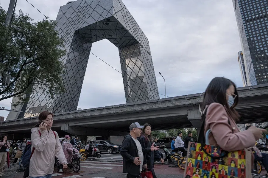 Pedestrians cross a road in Beijing, China, 20 September 2024.