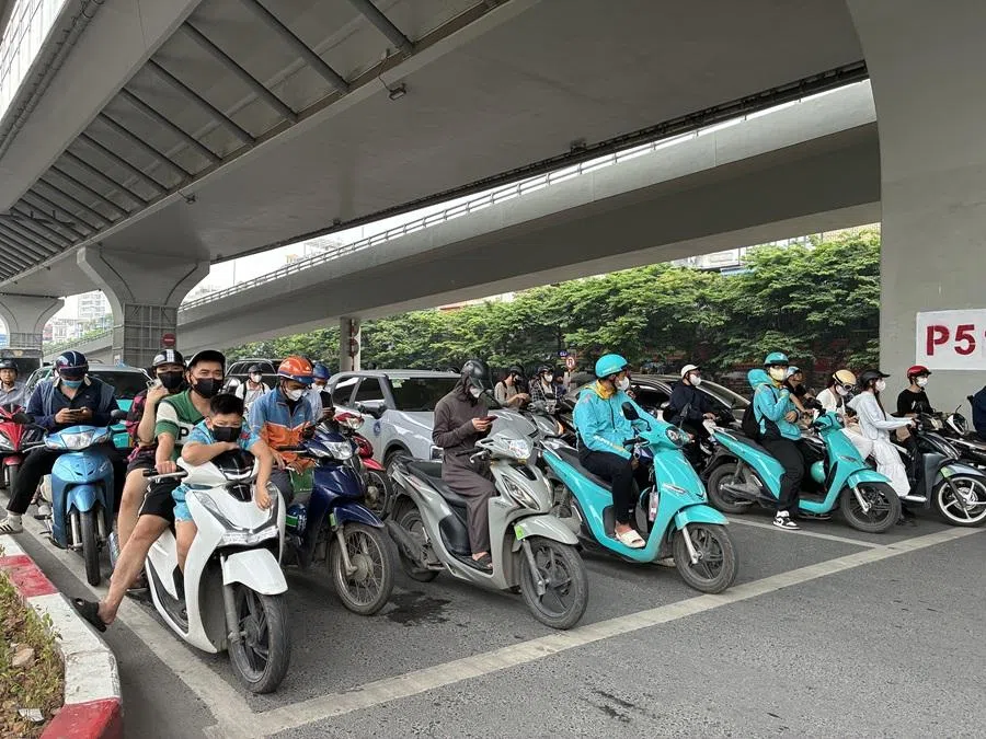 Cars and motorcycles wait at a traffic light in Hanoi, July 2025. (Nga Pham/SPH Media)