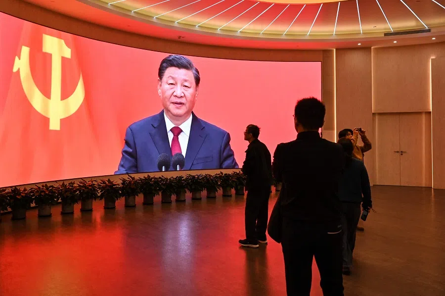 A screen shows images of China’s President Xi Jinping as people visit the Museum of the First National Congress of the Chinese Communist Party in Shanghai on 27 February 2025. (Hector Retamal/AFP)